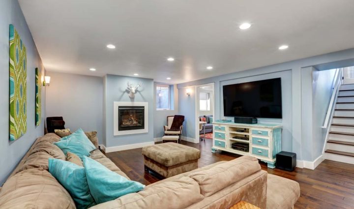 A modern and cozy living room with a plush sectional sofa, contemporary fireplace, and stylish decor, creating a warm and inviting space for relaxation.
