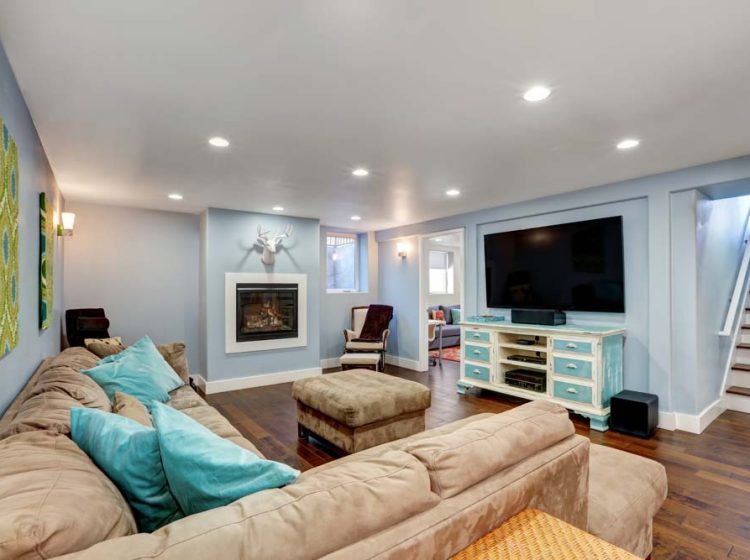 A modern and cozy living room with a plush sectional sofa, contemporary fireplace, and stylish decor, creating a warm and inviting space for relaxation.